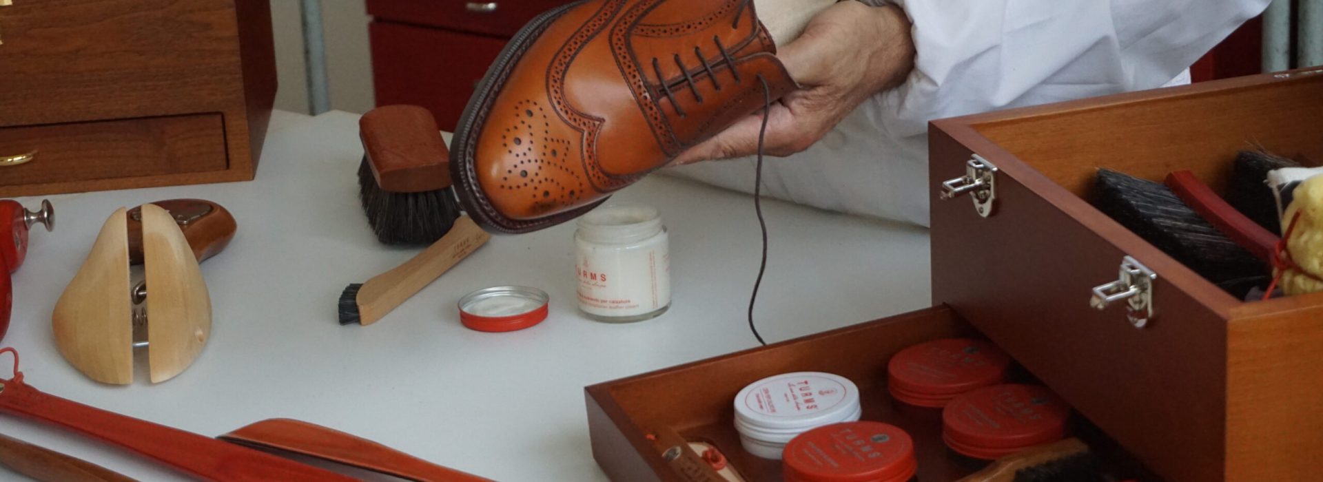 Man cleaning luxury shoe